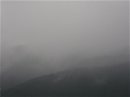 画像: 雨模様、山に霧。